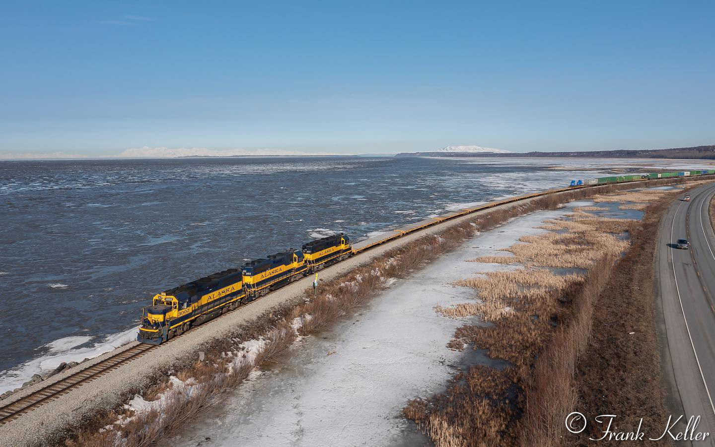 A lengthy Whittier freight curves along Turnagain Arm on a late spring morning.